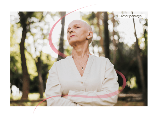 Actor portrayal of female oncology patient standing outside