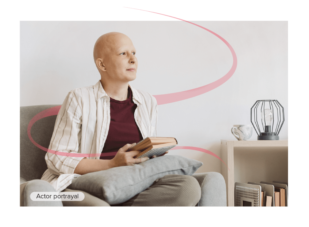 Actor portrayal of oncology patient sitting with a book