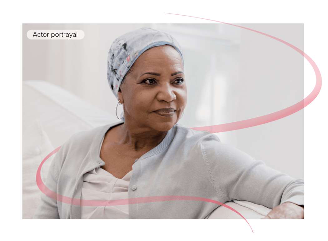 Actor portrayal of woman with cancer sitting indoors